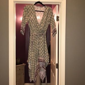 Mock wrap dress w Shark bite hemline & waist tie.